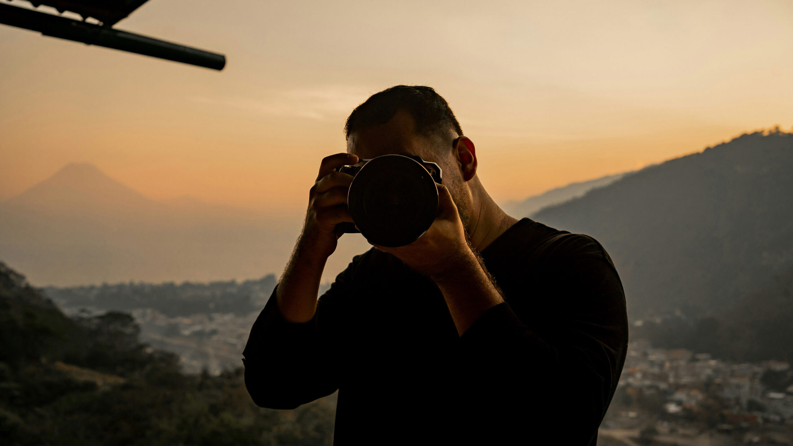 Photographe capturant un portrait au coucher du soleil, maîtrise de la lumière et intention artistique.